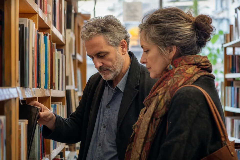 A man and a woman in their fifties browsing shelves together in an independent bookstore